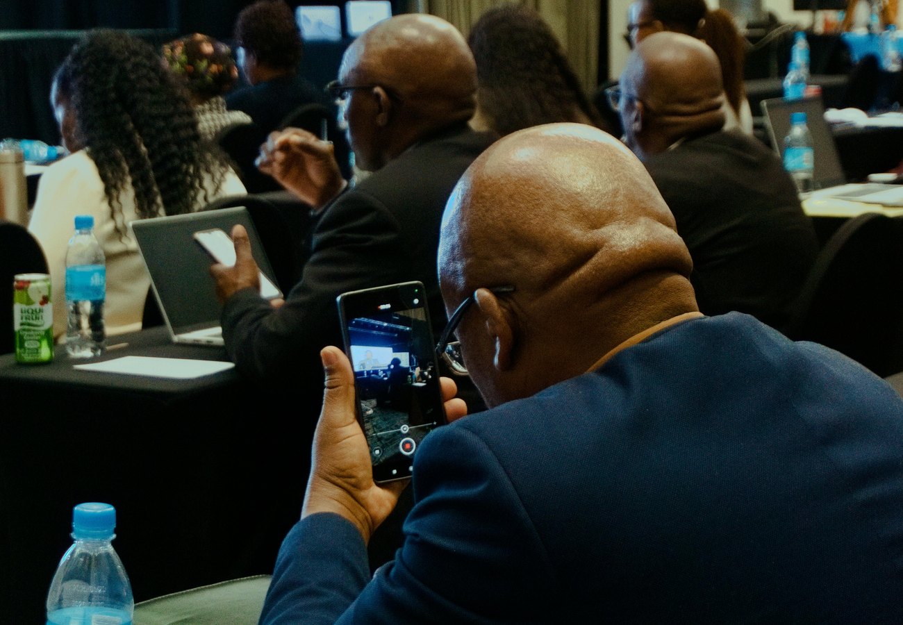Business conference attendees listening to a speaker